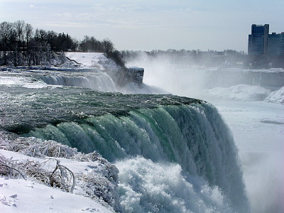 [Huge amounts of water pouring off the top of the falls.]